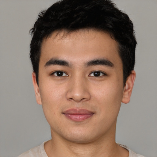 Joyful asian young-adult male with short  black hair and brown eyes