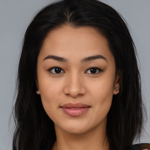 Joyful asian young-adult female with long  brown hair and brown eyes
