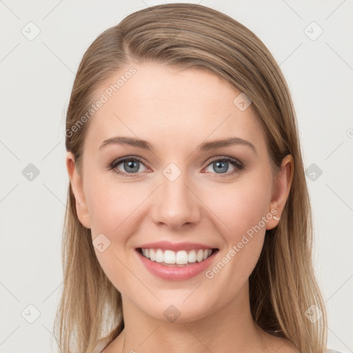 Joyful white young-adult female with long  brown hair and blue eyes