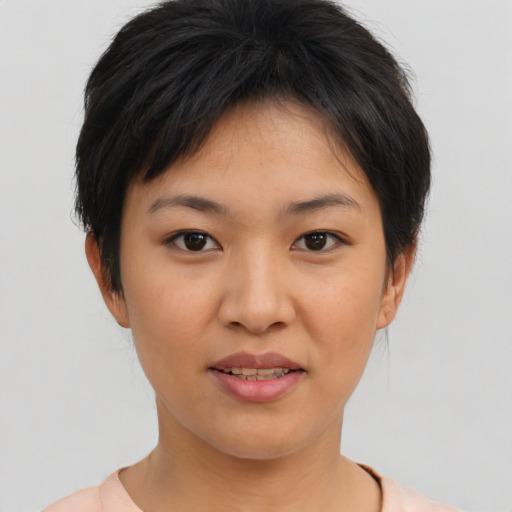 Joyful asian young-adult female with short  brown hair and brown eyes