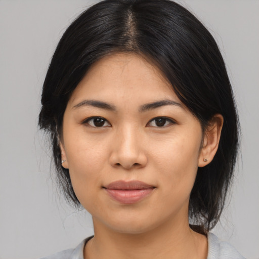 Joyful asian young-adult female with medium  black hair and brown eyes