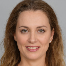 Joyful white young-adult female with long  brown hair and green eyes