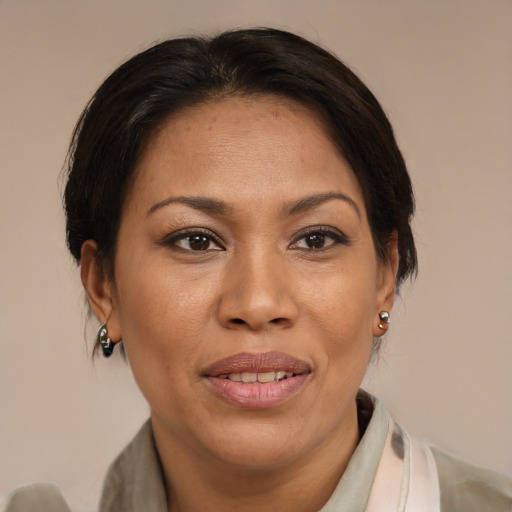 Joyful black adult female with medium  brown hair and brown eyes