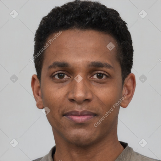 Joyful black young-adult male with short  black hair and brown eyes