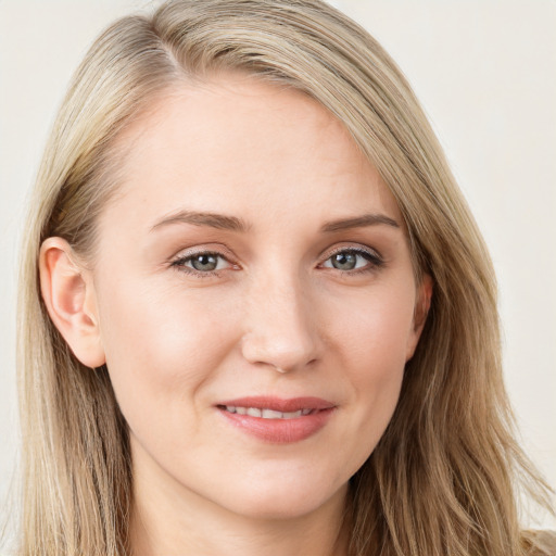 Joyful white young-adult female with long  brown hair and blue eyes