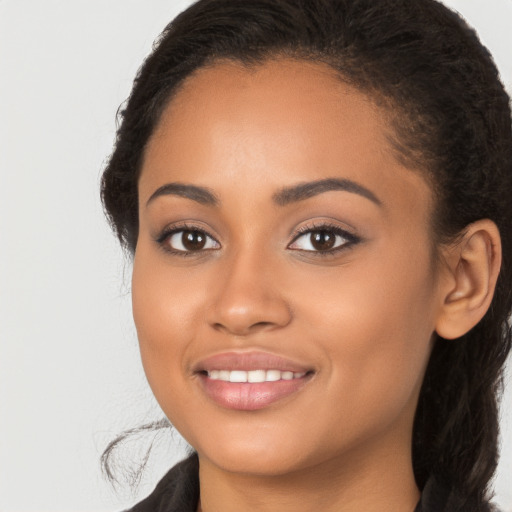 Joyful latino young-adult female with long  brown hair and brown eyes