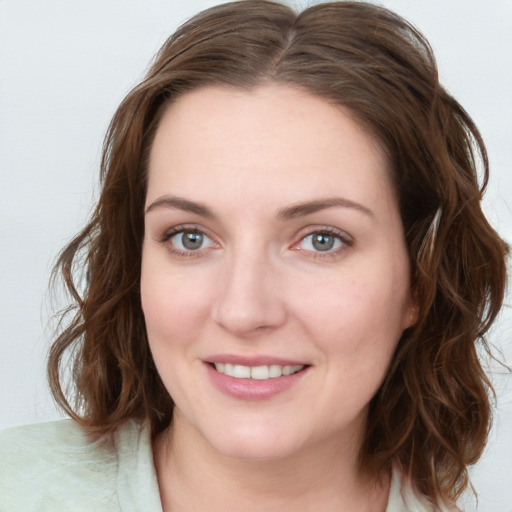 Joyful white young-adult female with medium  brown hair and blue eyes