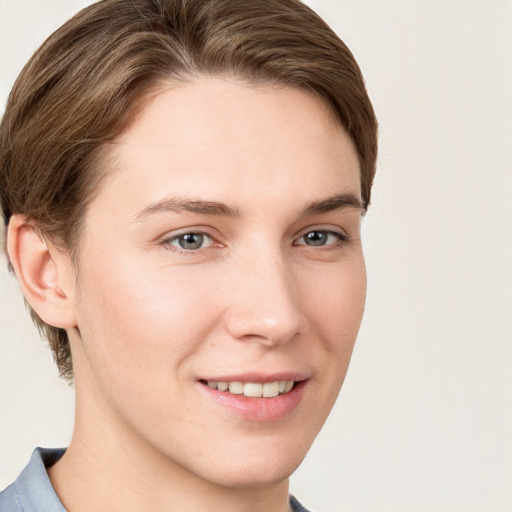 Joyful white young-adult female with short  brown hair and grey eyes