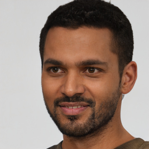 Joyful latino young-adult male with short  black hair and brown eyes