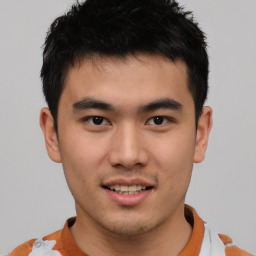 Joyful asian young-adult male with short  black hair and brown eyes