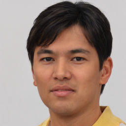 Joyful asian young-adult male with short  black hair and brown eyes