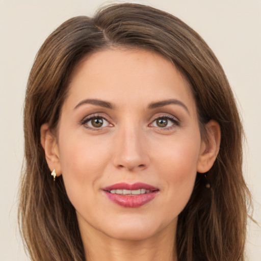 Joyful white adult female with long  brown hair and brown eyes