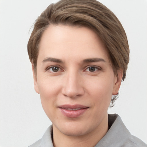 Joyful white young-adult female with short  brown hair and grey eyes