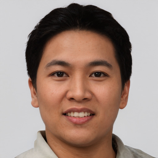 Joyful asian young-adult male with short  black hair and brown eyes