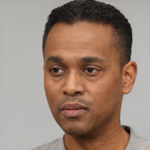 Neutral black young-adult male with short  black hair and brown eyes
