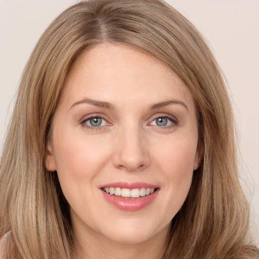 Joyful white young-adult female with long  brown hair and brown eyes