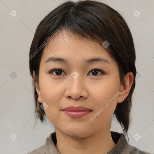 Joyful asian young-adult female with medium  brown hair and brown eyes