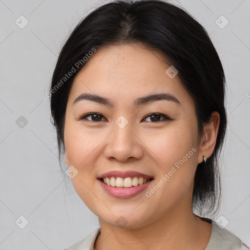 Joyful asian young-adult female with medium  brown hair and brown eyes