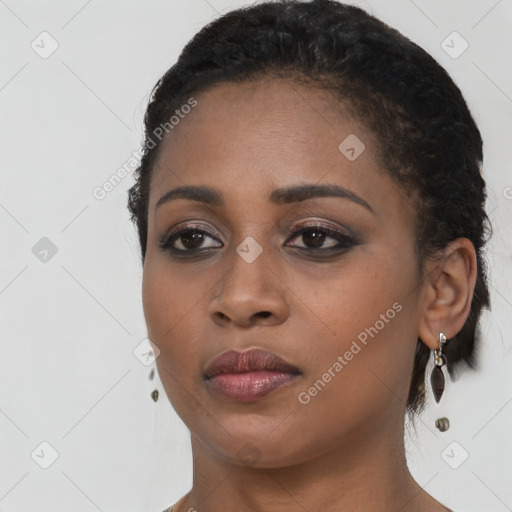 Joyful black young-adult female with short  black hair and brown eyes