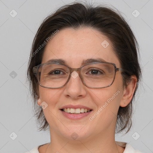 Joyful white adult female with medium  brown hair and brown eyes