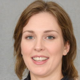 Joyful white young-adult female with medium  brown hair and blue eyes