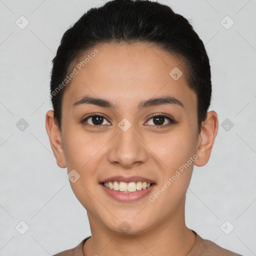 Joyful latino young-adult female with short  brown hair and brown eyes