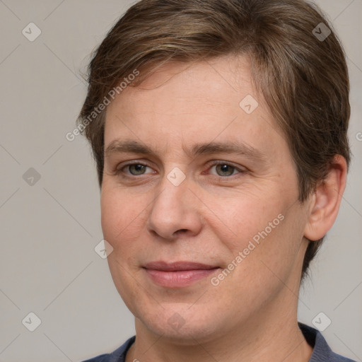 Joyful white adult female with short  brown hair and grey eyes