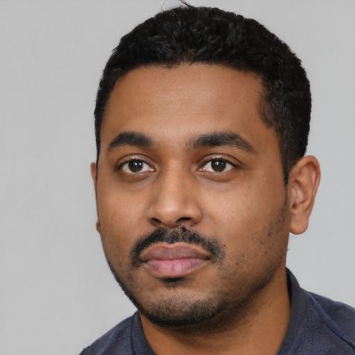 Neutral black young-adult male with short  black hair and brown eyes