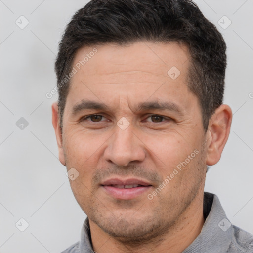 Joyful white adult male with short  brown hair and brown eyes