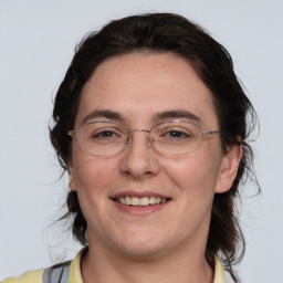 Joyful white adult female with medium  brown hair and brown eyes