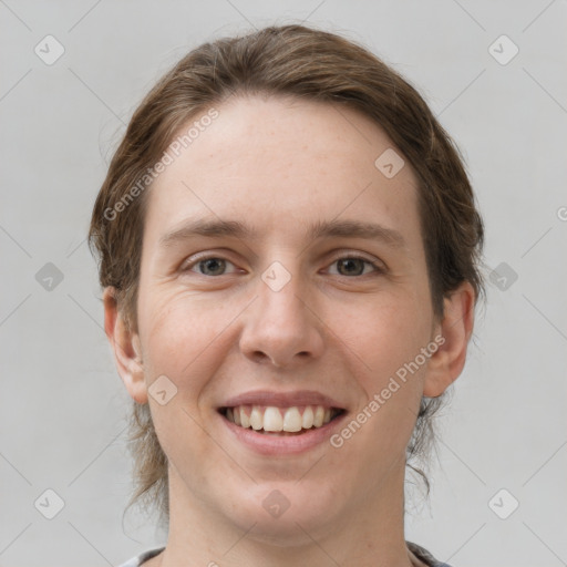 Joyful white young-adult female with medium  brown hair and grey eyes