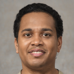 Joyful latino young-adult male with short  brown hair and brown eyes