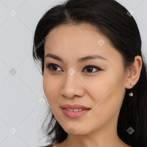 Joyful asian young-adult female with long  brown hair and brown eyes