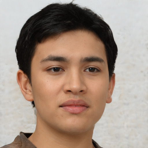 Joyful asian young-adult male with short  black hair and brown eyes