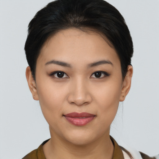 Joyful asian young-adult female with short  brown hair and brown eyes