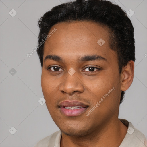 Joyful black young-adult male with short  black hair and brown eyes