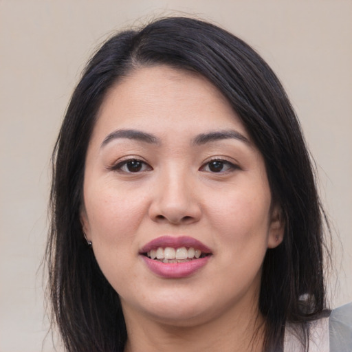 Joyful asian young-adult female with medium  black hair and brown eyes