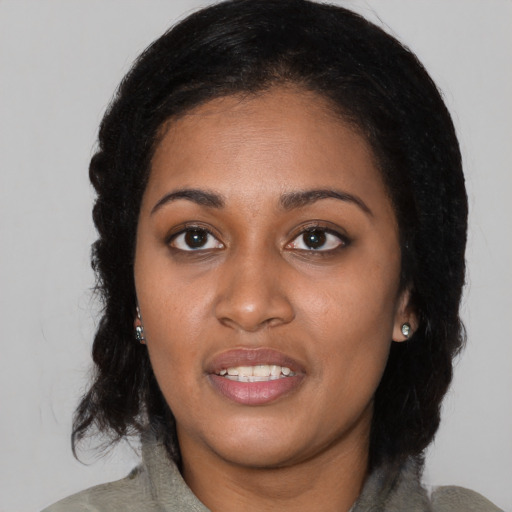 Joyful latino young-adult female with medium  black hair and brown eyes