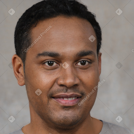 Joyful black young-adult male with short  brown hair and brown eyes