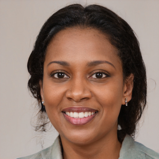 Joyful black young-adult female with medium  brown hair and brown eyes