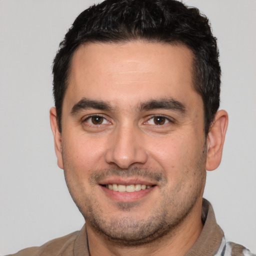 Joyful white young-adult male with short  brown hair and brown eyes