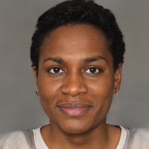 Joyful black young-adult female with short  black hair and brown eyes