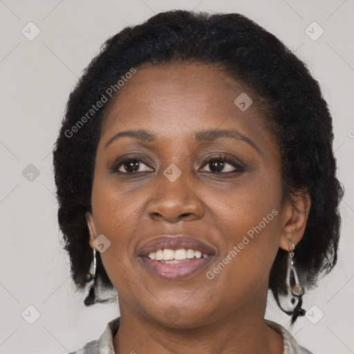 Joyful black adult female with medium  brown hair and brown eyes