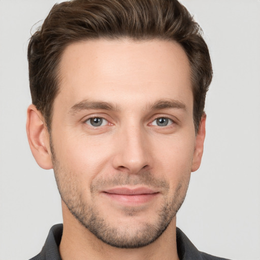 Joyful white young-adult male with short  brown hair and brown eyes