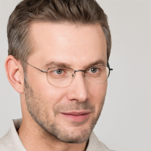 Joyful white adult male with short  brown hair and grey eyes