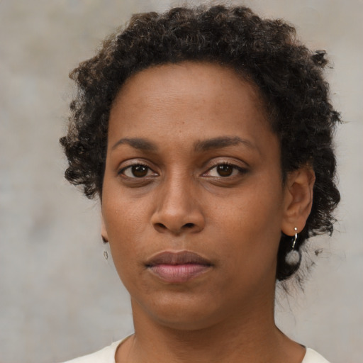 Neutral black young-adult female with short  brown hair and brown eyes