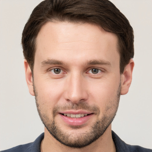 Joyful white young-adult male with short  brown hair and brown eyes