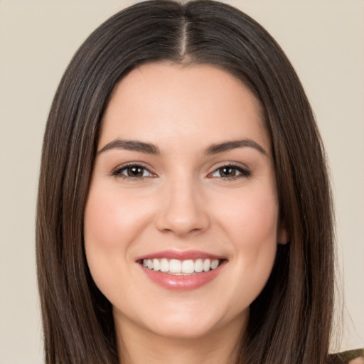 Joyful white young-adult female with long  brown hair and brown eyes