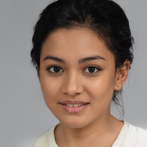 Joyful latino young-adult female with medium  black hair and brown eyes