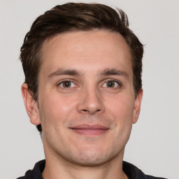 Joyful white adult male with short  brown hair and grey eyes